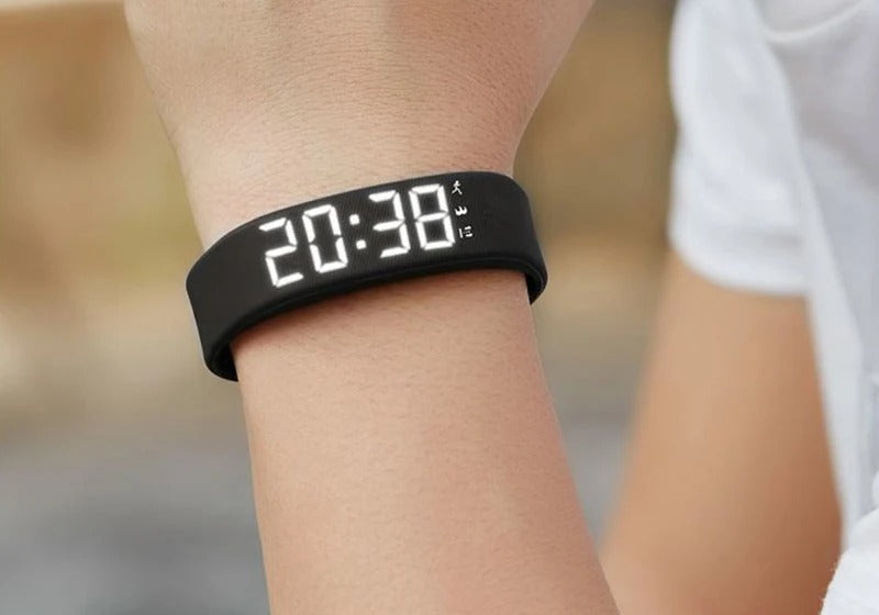 The Silent Wake Band worn on the wrist, LED display showing the time.